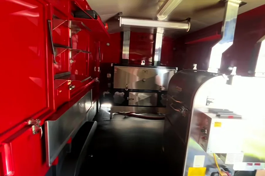 After: the red trailer interior with a clean floor and polished stainless