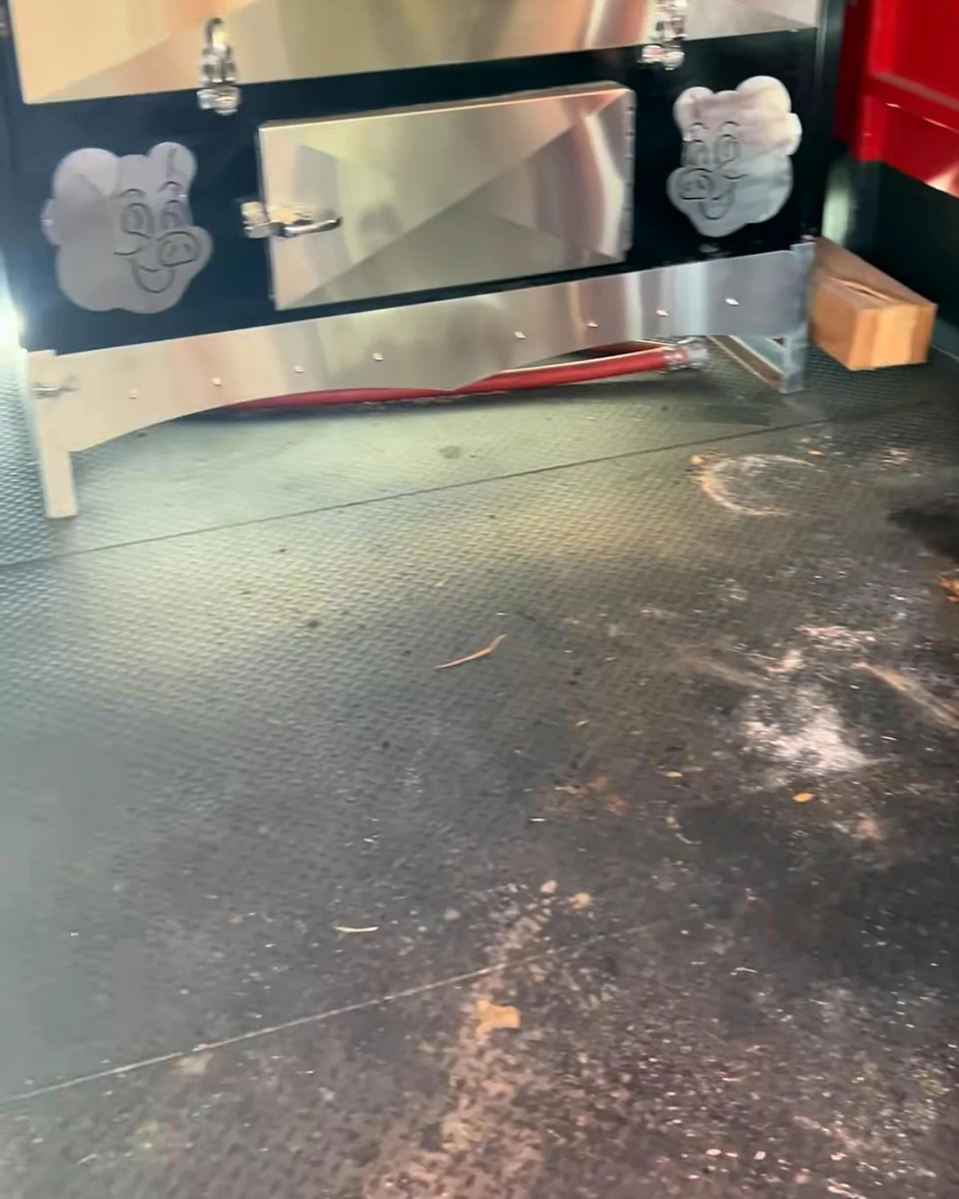 Before: a trailer floor covered in dust and debris next to a stainless cabinet