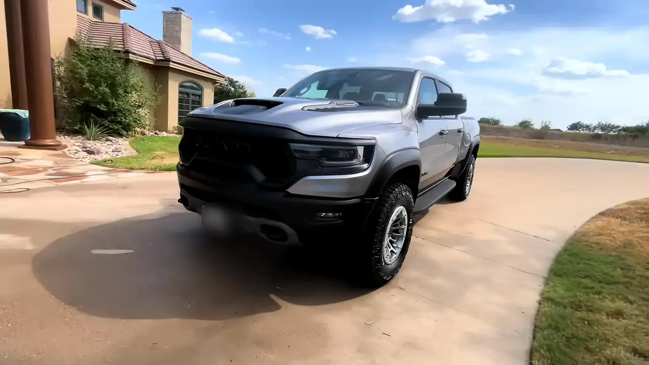 A silver Ram TRX after a full detail, parked on a curved concrete drive