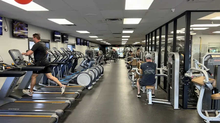 The cardio aisle, members on the machines either side
