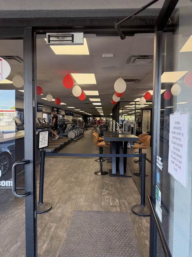 Looking in from the sidewalk through the propped-open door