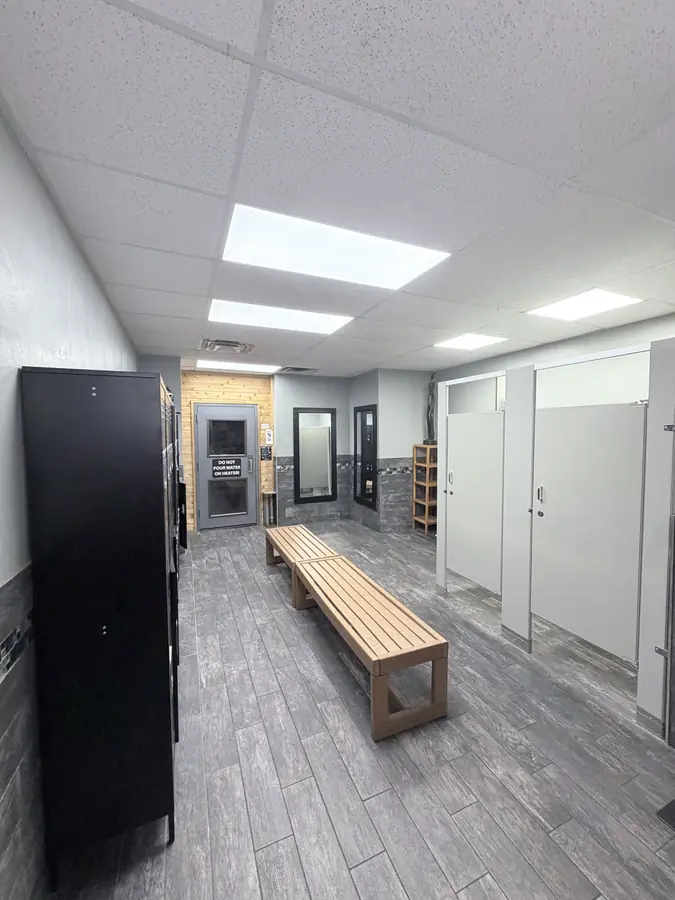 The locker room, benches and shower stalls