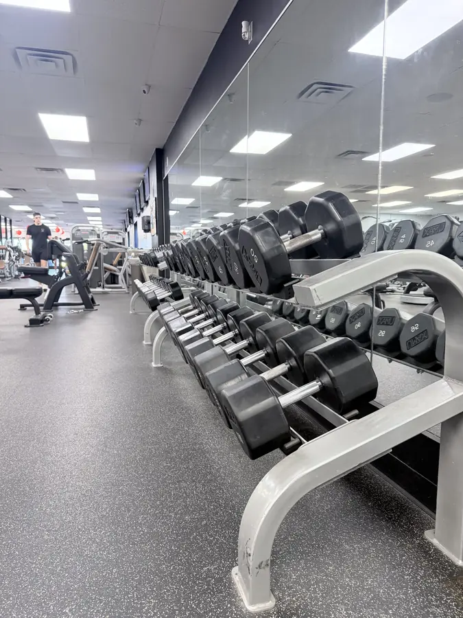Hex dumbbells running away down the mirror wall