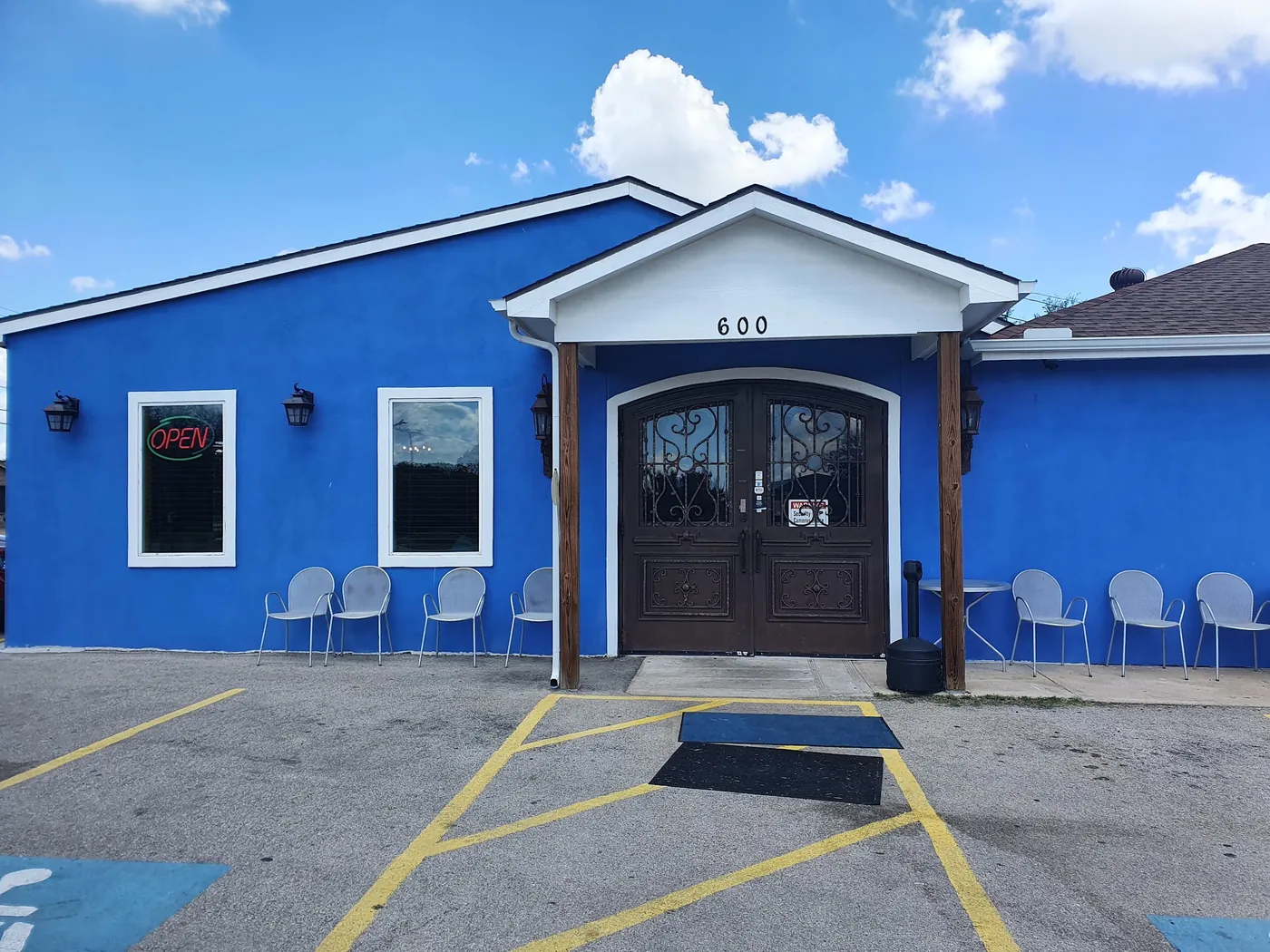 La Pasadita's bright blue building with arched wooden doors