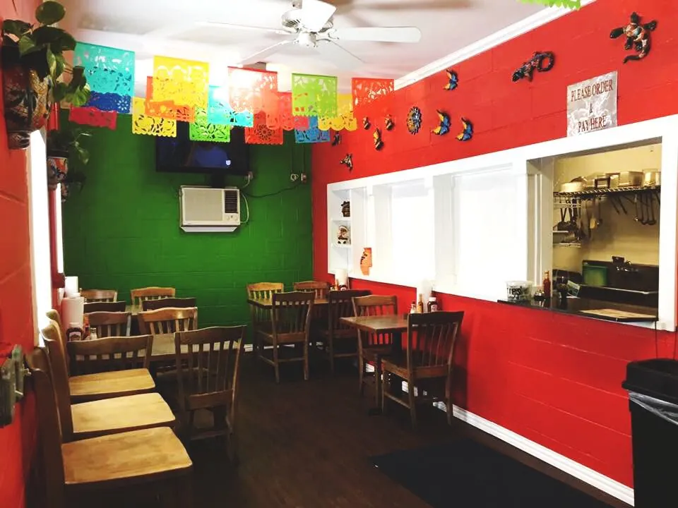 Tables under papel picado beside the kitchen window