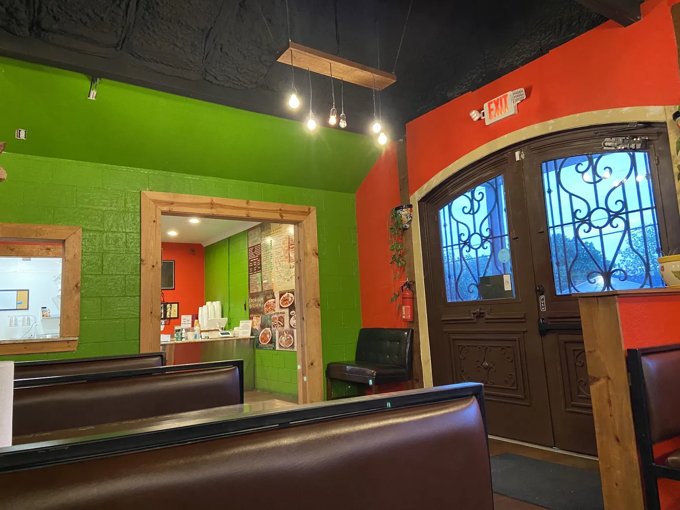 The dining room: lime green and red walls, booths and the front doors