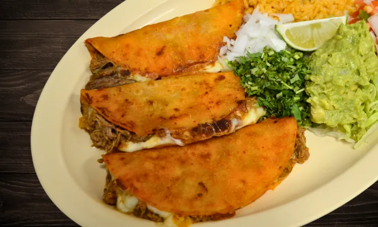 Quesabirria plate with rice, guacamole, pico de gallo, cilantro and onion