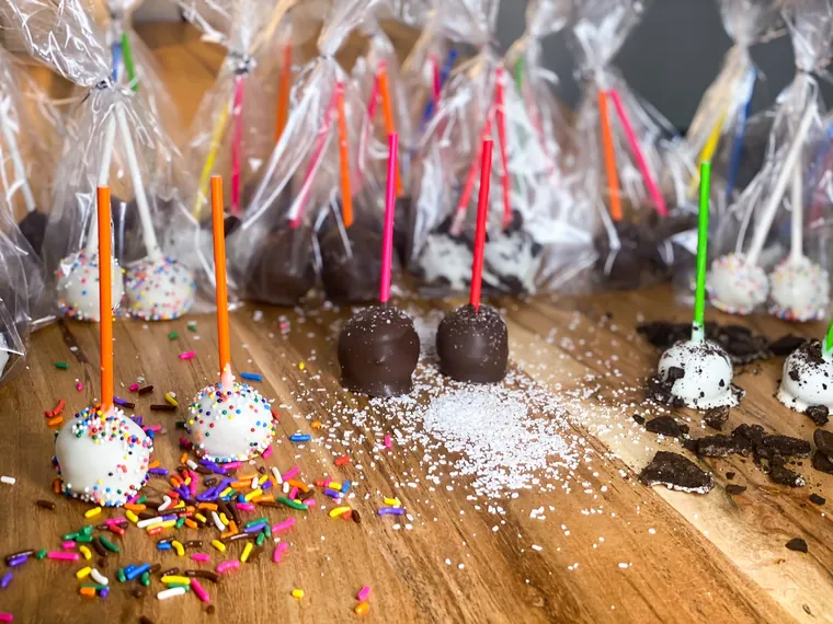 Chocolate and white cake pops covered in sprinkles