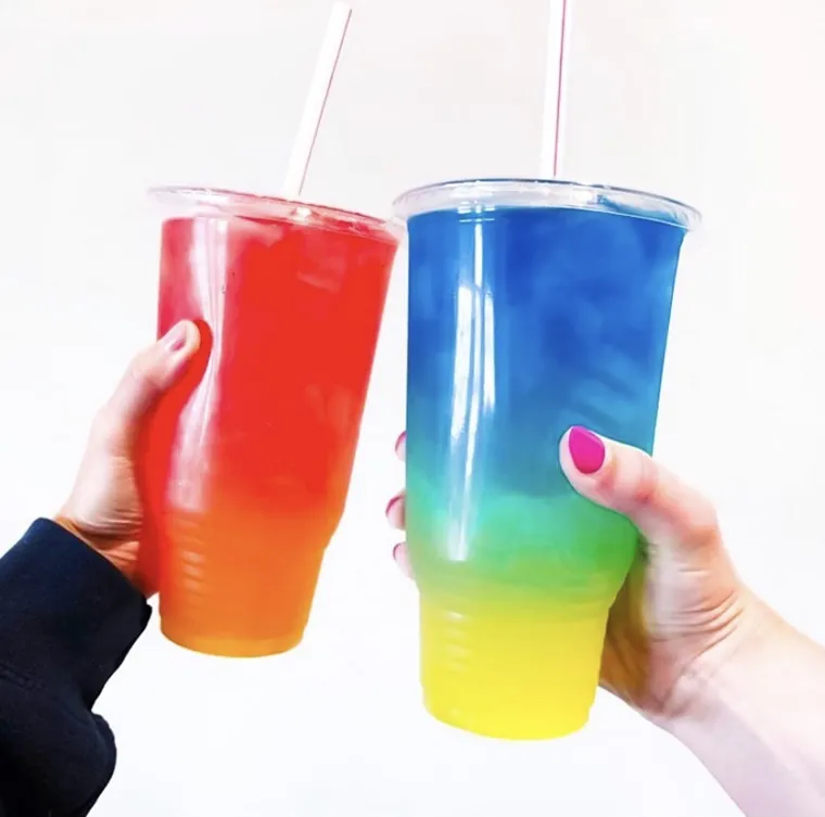 Two layered teas held up together, red into orange and blue into green into yellow