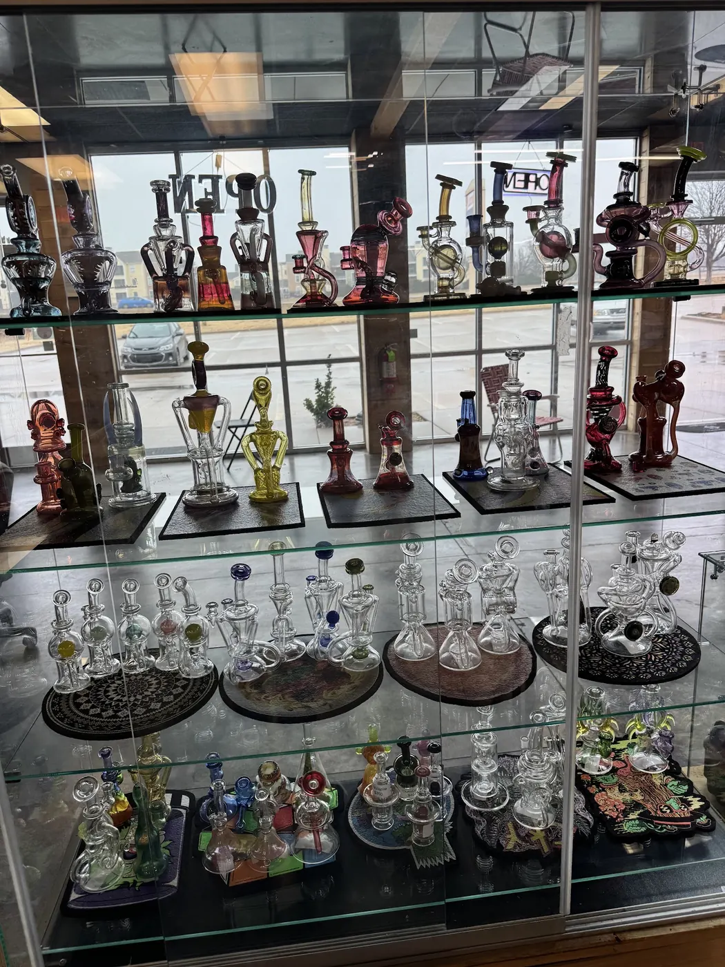 A glass display case of recyclers and rigs in the front window
