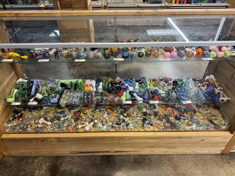 A case full of colorful glass hand pipes